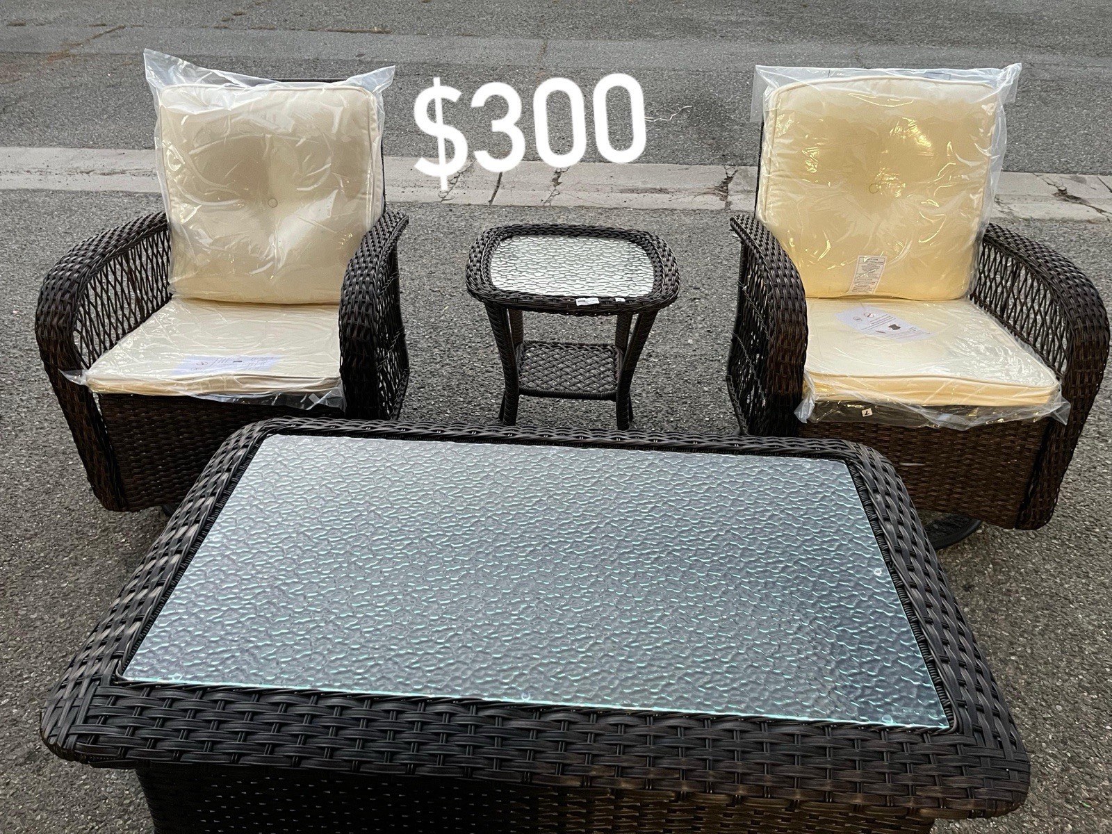4-Piece Brown Wicker Patio Lounge Set, 2 Chairs, Beige Cushions, Glass Table